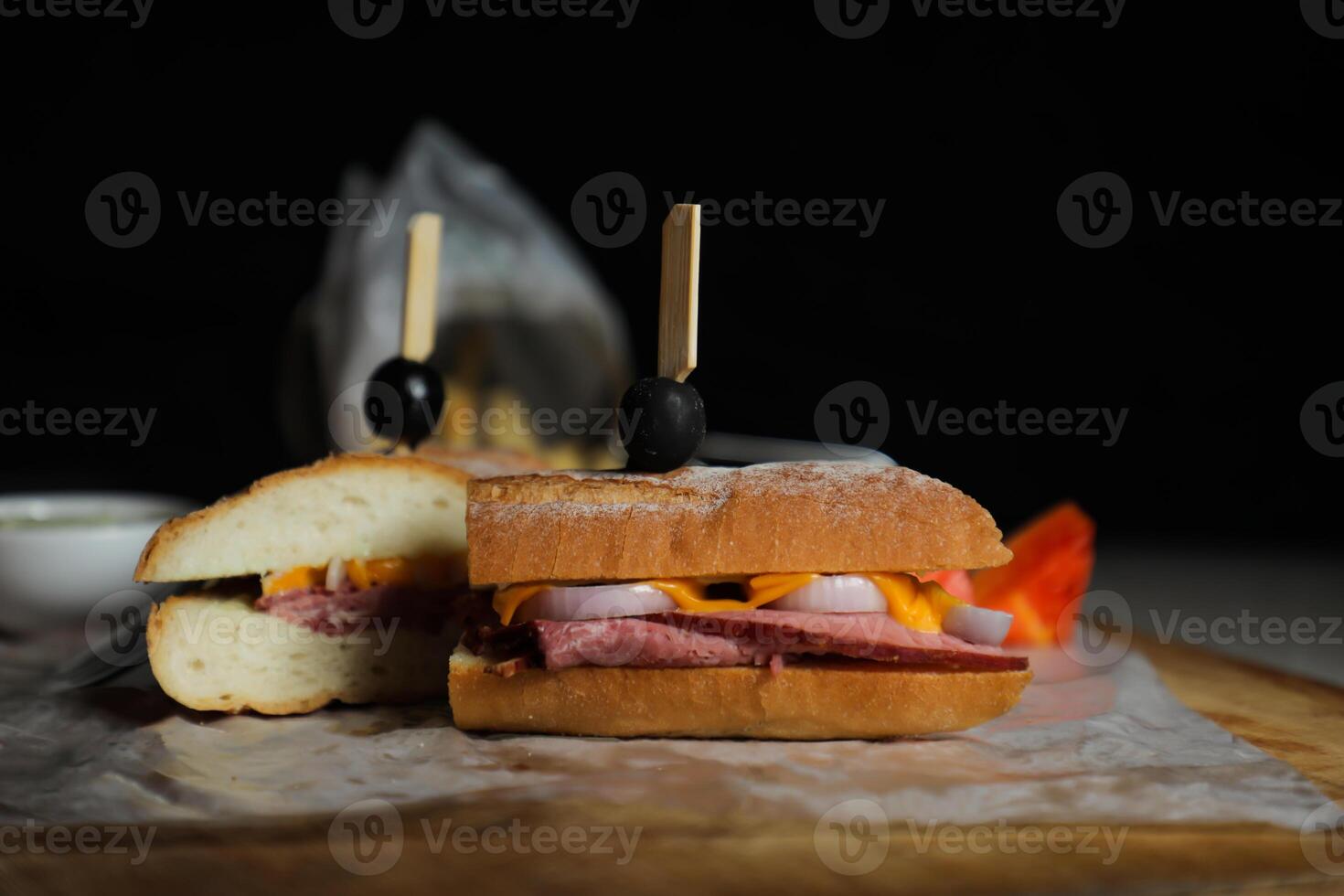Robust Roast Beef Cheddar Sandwich with mayonnaise dip with fries served in wooden board isolated on napkin side view of breakfast food photo