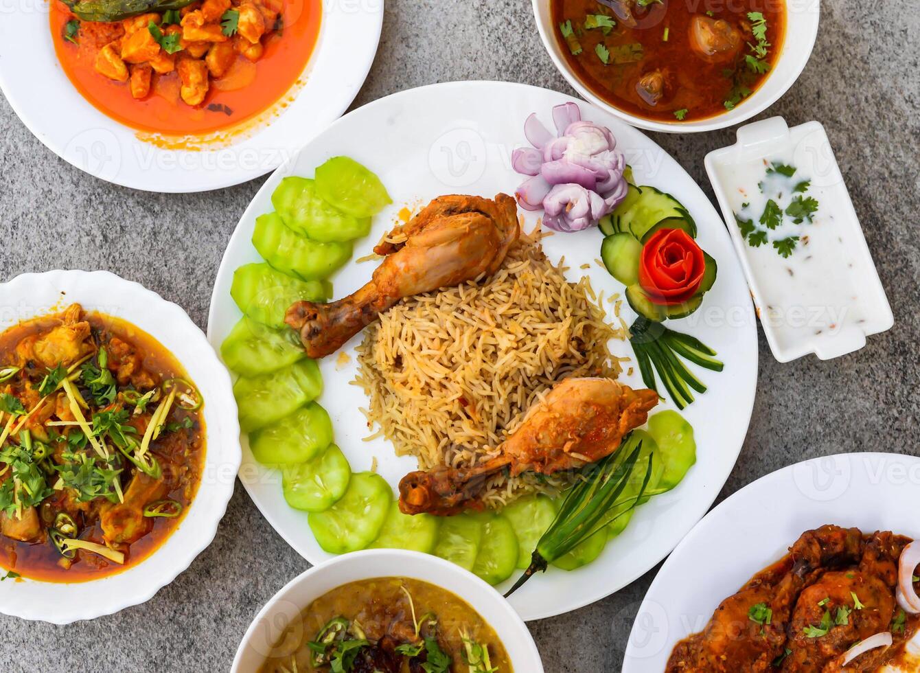 steam chicken biryani pulao rice, makhni chicken boneless handi, haleem, chicken karahi, korma, nihari, tandoori, salad and raita served isolated on background top view of indian and pakistani food photo
