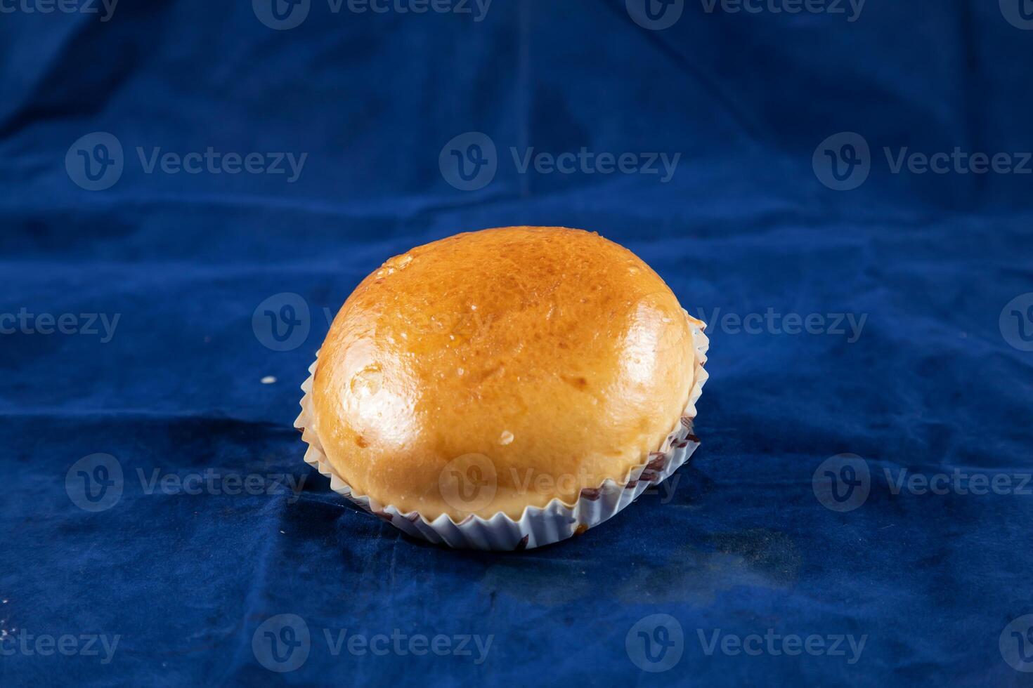 Meat Bun isolated on blue background side view of savory snack food photo