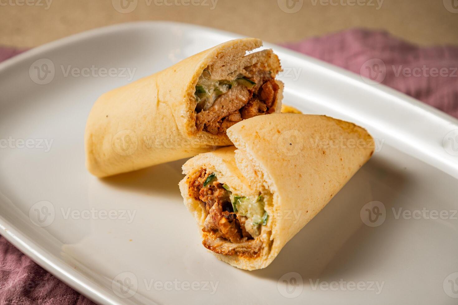 Arabian Chicken Shawarma filled with meat, cucumber and mayonnaise served in dish isolated on table side view of lebanese food photo