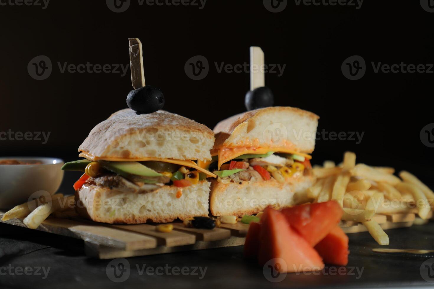 Spicy Southwest Chicken Sandwich with fries and mayonnaise dip served in tray isolated on dark background side view of breakfast food photo