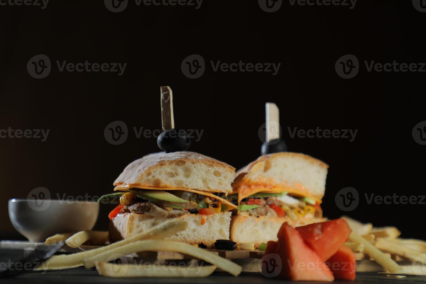 Spicy Southwest Chicken Sandwich with fries and mayonnaise dip served in tray isolated on dark background side view of breakfast food photo