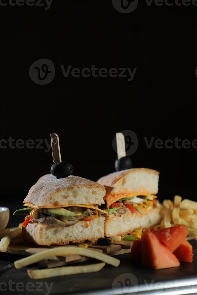 Spicy Southwest Chicken Sandwich with fries and mayonnaise dip served in tray isolated on dark background side view of breakfast food photo