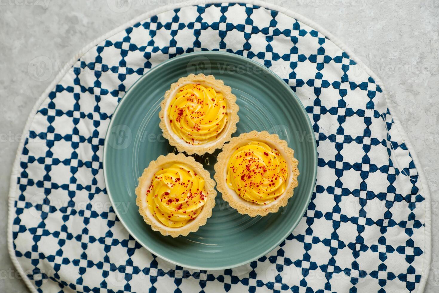 Lemon Tart muffin cup cake served in plate isolated on napkin top view of cafe baked food on background photo