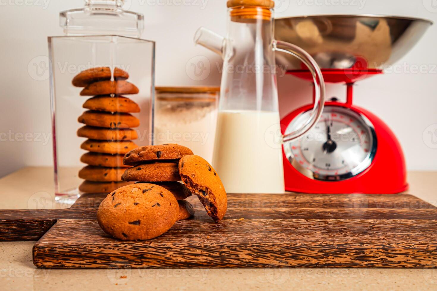 Tasty Chocolate cookie with jug of milk served on wooden board side view of healthy breakfast on table photo