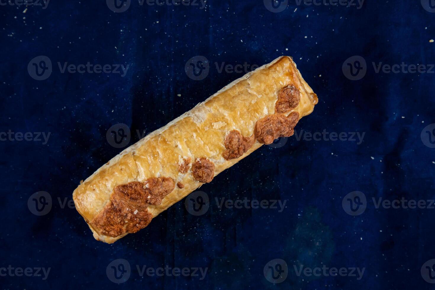 Vegetable roll isolated on blue background side view of savory snack food photo