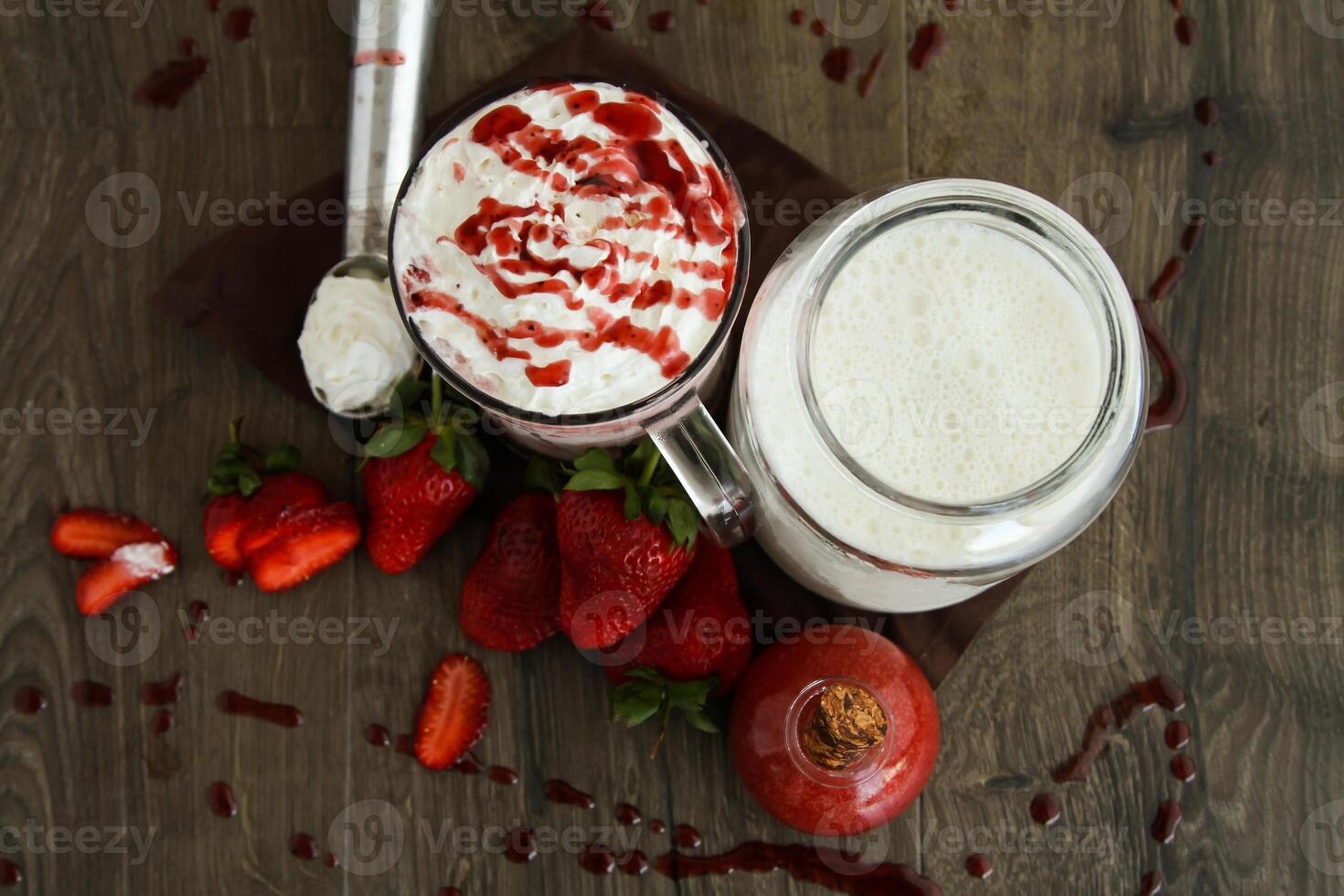 Strawberry vanilla ice cream shake served in glass isolated on table top view of healthy drink photo