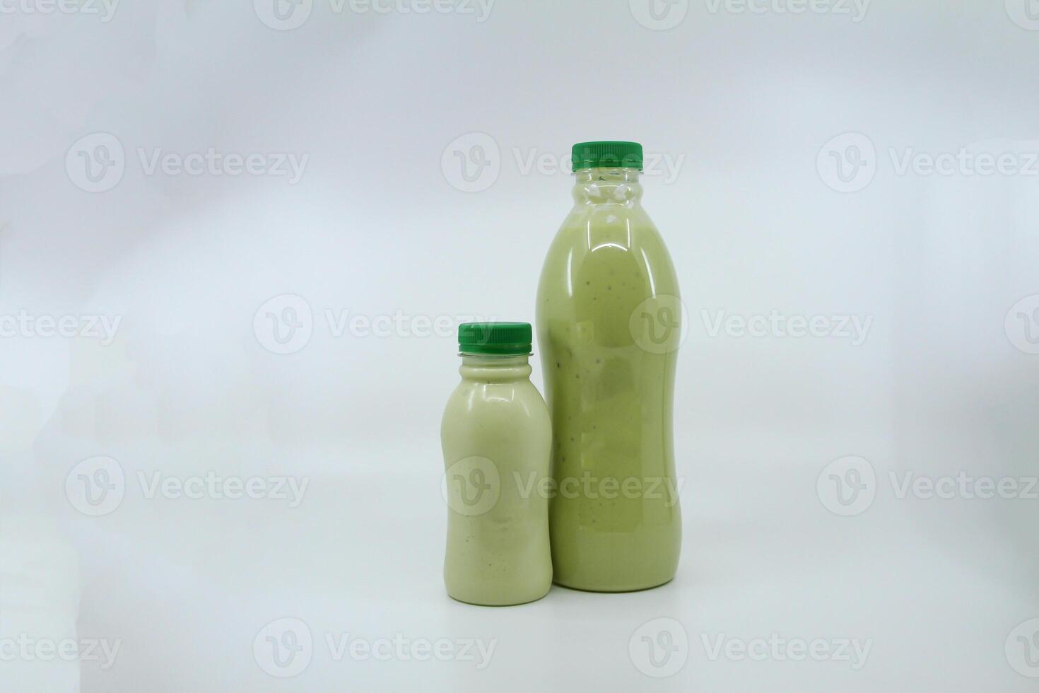 Fresh avocado juice served in bottle isolated on background side view of healthy morning juice drink photo