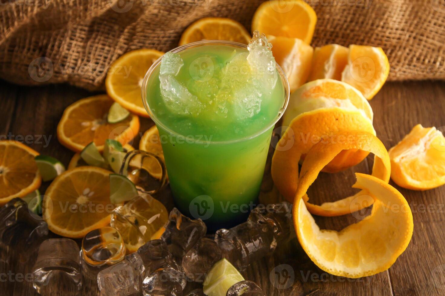 lemon mint and orange juice served in disposable glass isolated on table side view of healthy drink photo