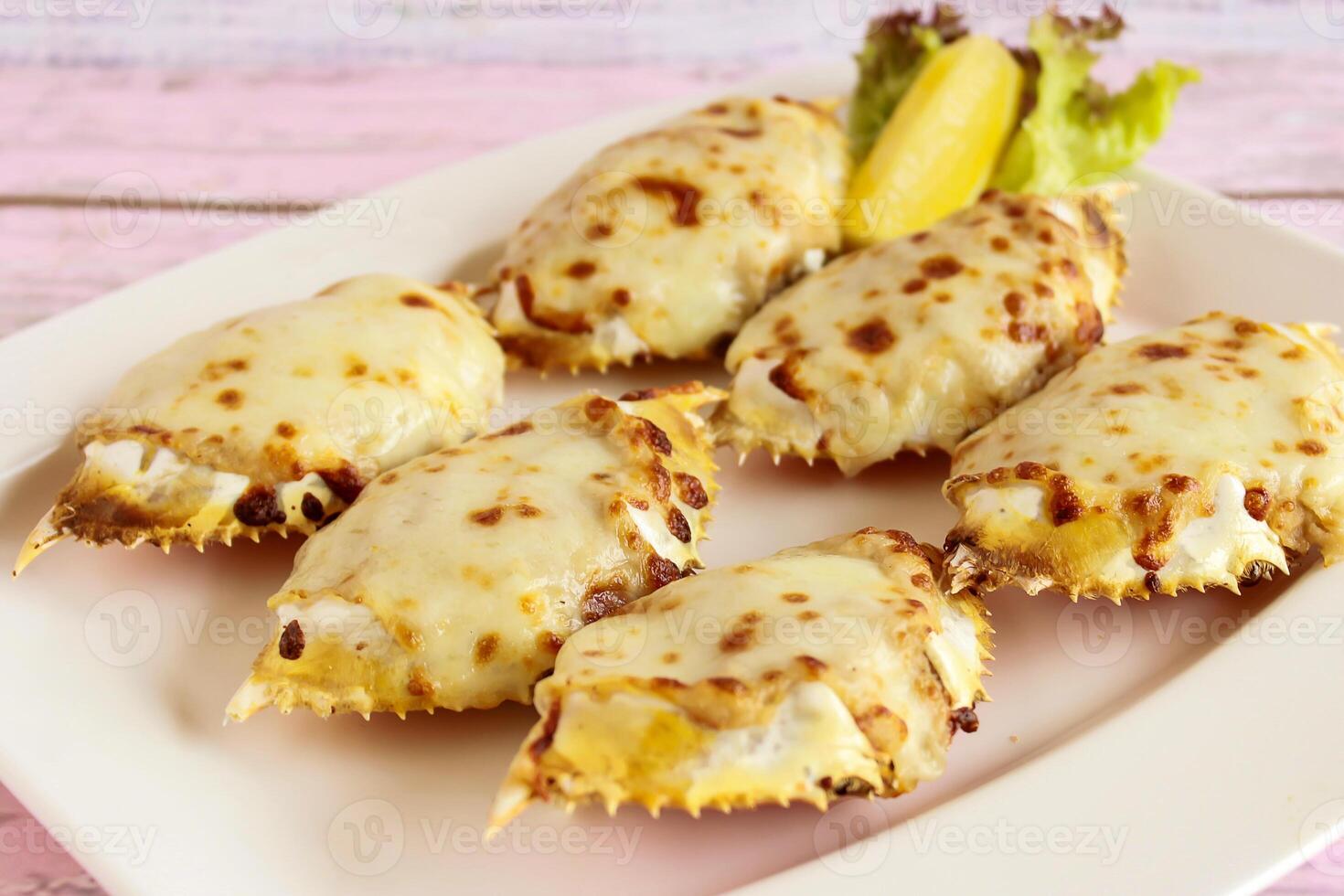 STUFFED CRABS served in dish isolated on table closeup top view of grilled seafood photo