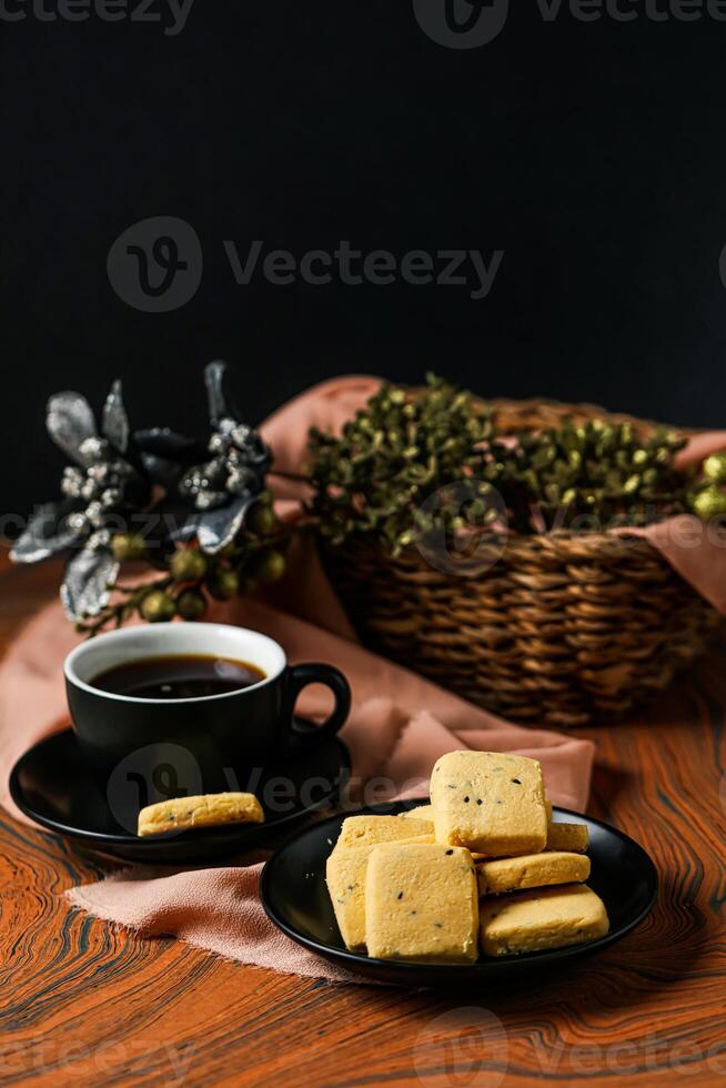 Crunchy cookies biscuits served in plate with black coffee isolated on table side view of american cafe baked food photo