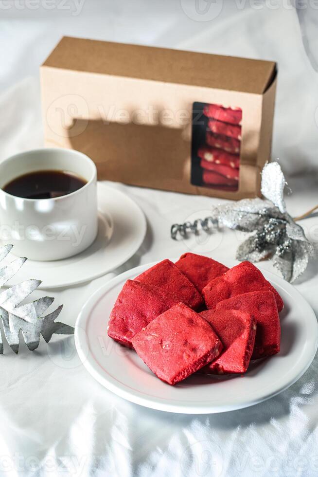 Crunchy cookies biscuits served in plate with cookie box and black coffee isolated on table side view of american cafe baked food photo