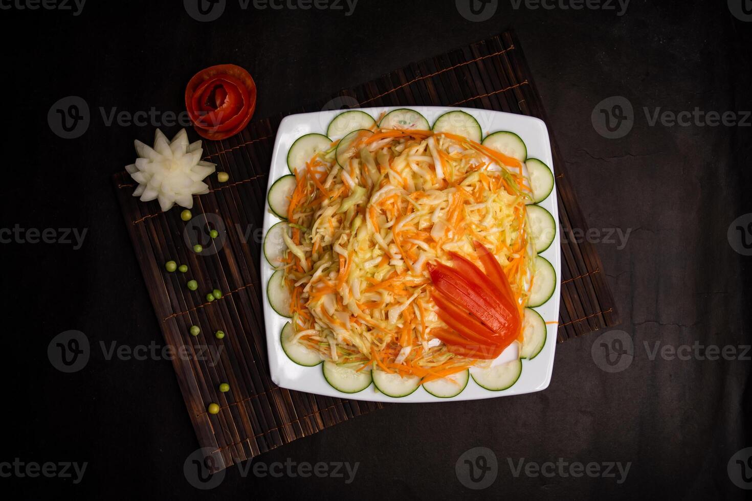 coleslaw salad or cole slaw with cucumber, cabbage, carrot, cream, mayo and tomato served in dish isolated on napkin mat top view of healthy supper food photo