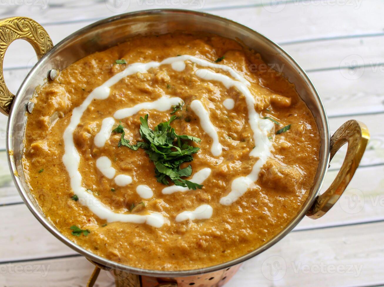 Chicken Korma Masala Gravy with Butter Cream served in karahi isolated on table closeup top view of indian spices food photo