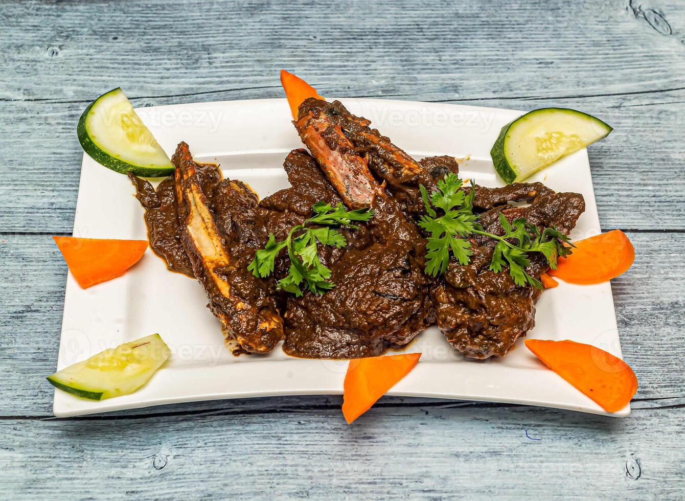 pepper crab served in dish isolated on wooden table top view of indian spicy food photo