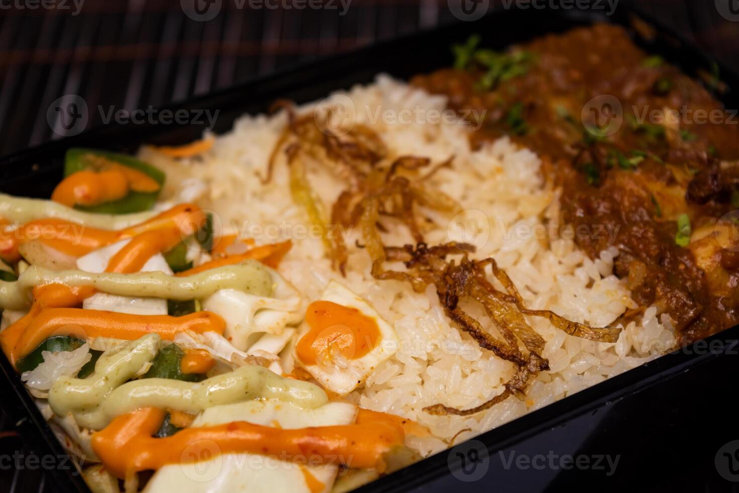 Chicken Bhuna with pulao biryani rice with cucumber, dip sauce and lemon slice served in dish isolated on wooden table side view closeup of bangladeshi and indian spices food photo