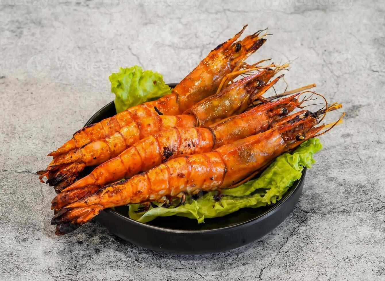 Grilled shrimp with salt and chili or tom nuong muoi ot with lettuce leaf served in dish isolated on grey background top view of singapore seafood photo