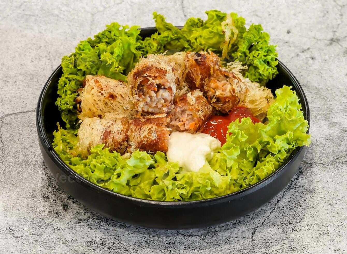 seafood spring rolls or cha gio ghe with lettuce leaf served in dish isolated on grey background top view of singapore seafood photo