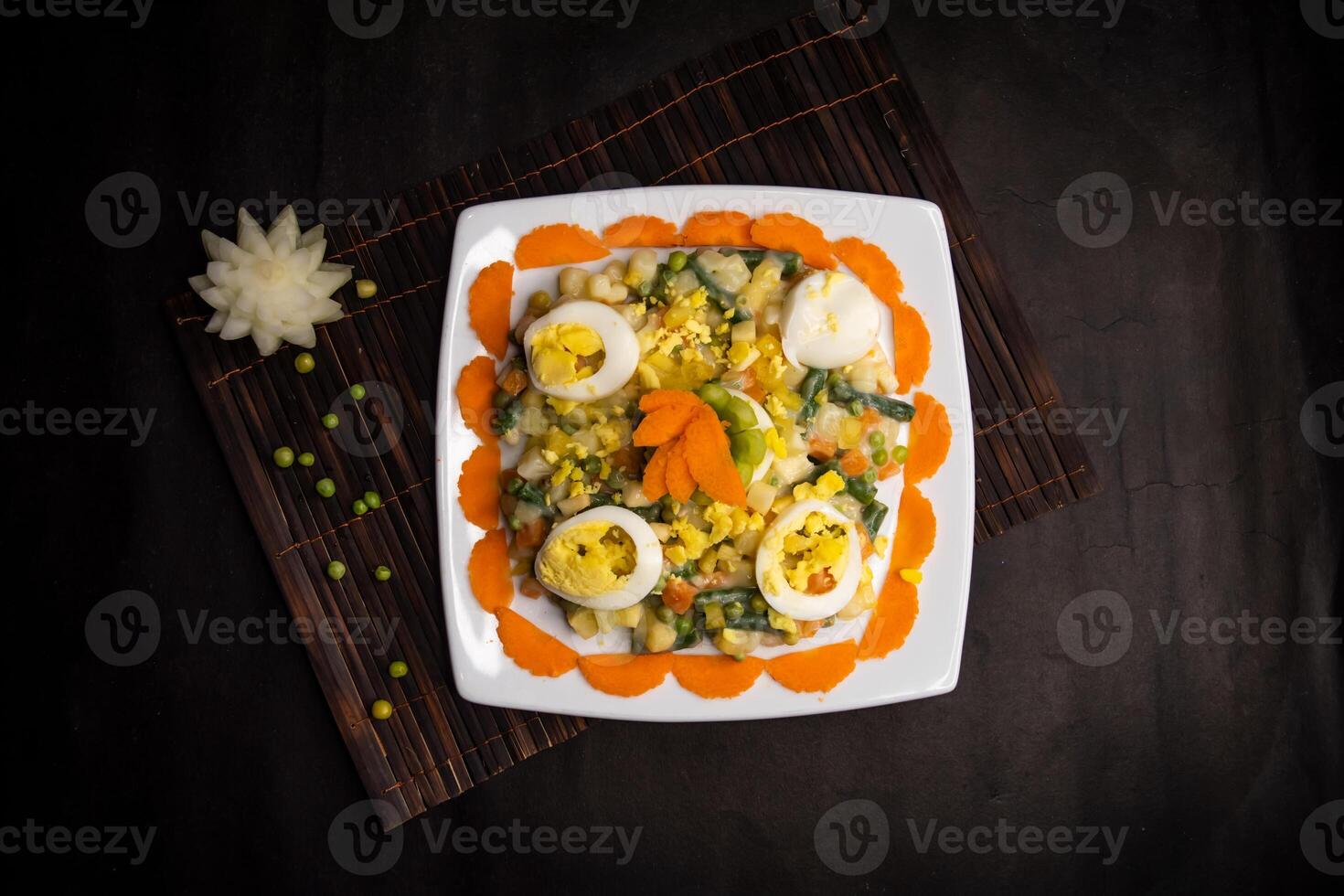 Russian salad served in dish isolated on napkin mat top view of healthy supper food photo