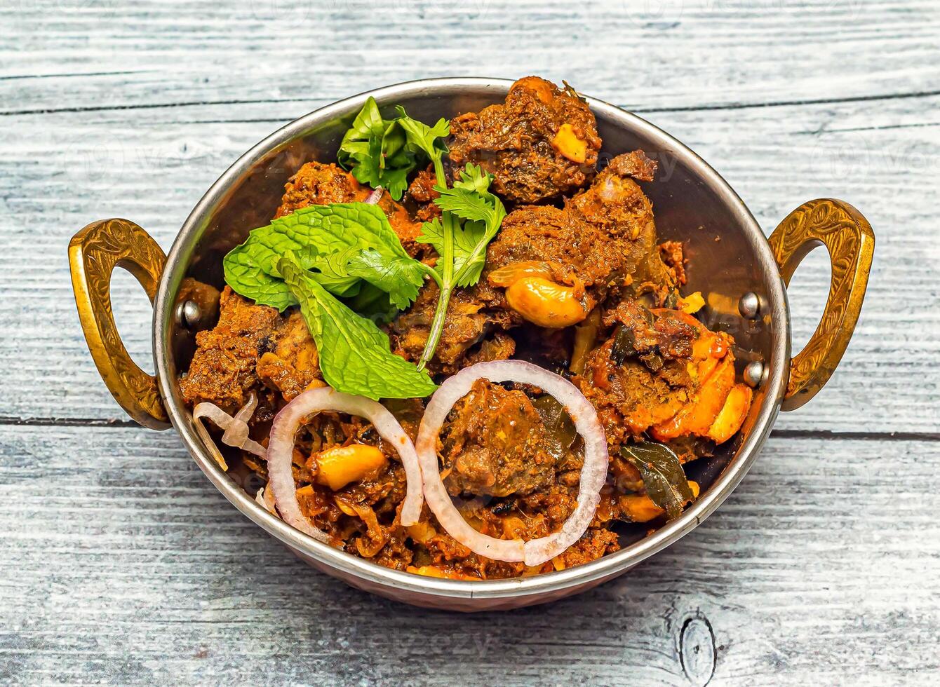 mysore mutton sukka bhuna karahi served in dish isolated on wooden table top view of indian spicy food photo