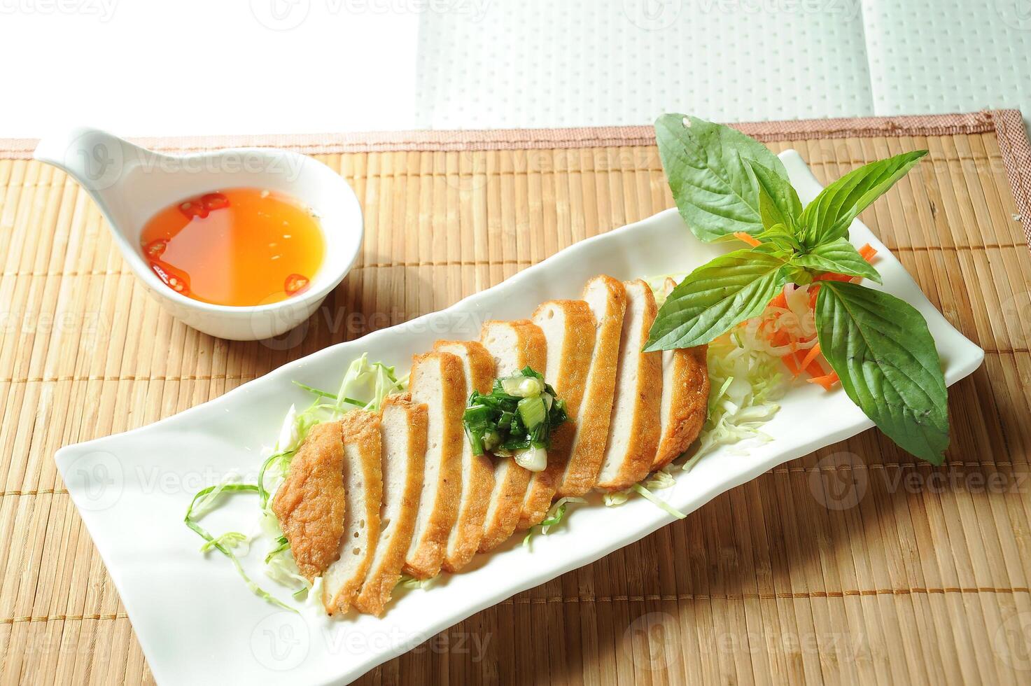 Vietnamese Style Fried Pork with chilli sauce served in dish isolated of table top view fast food snacks photo