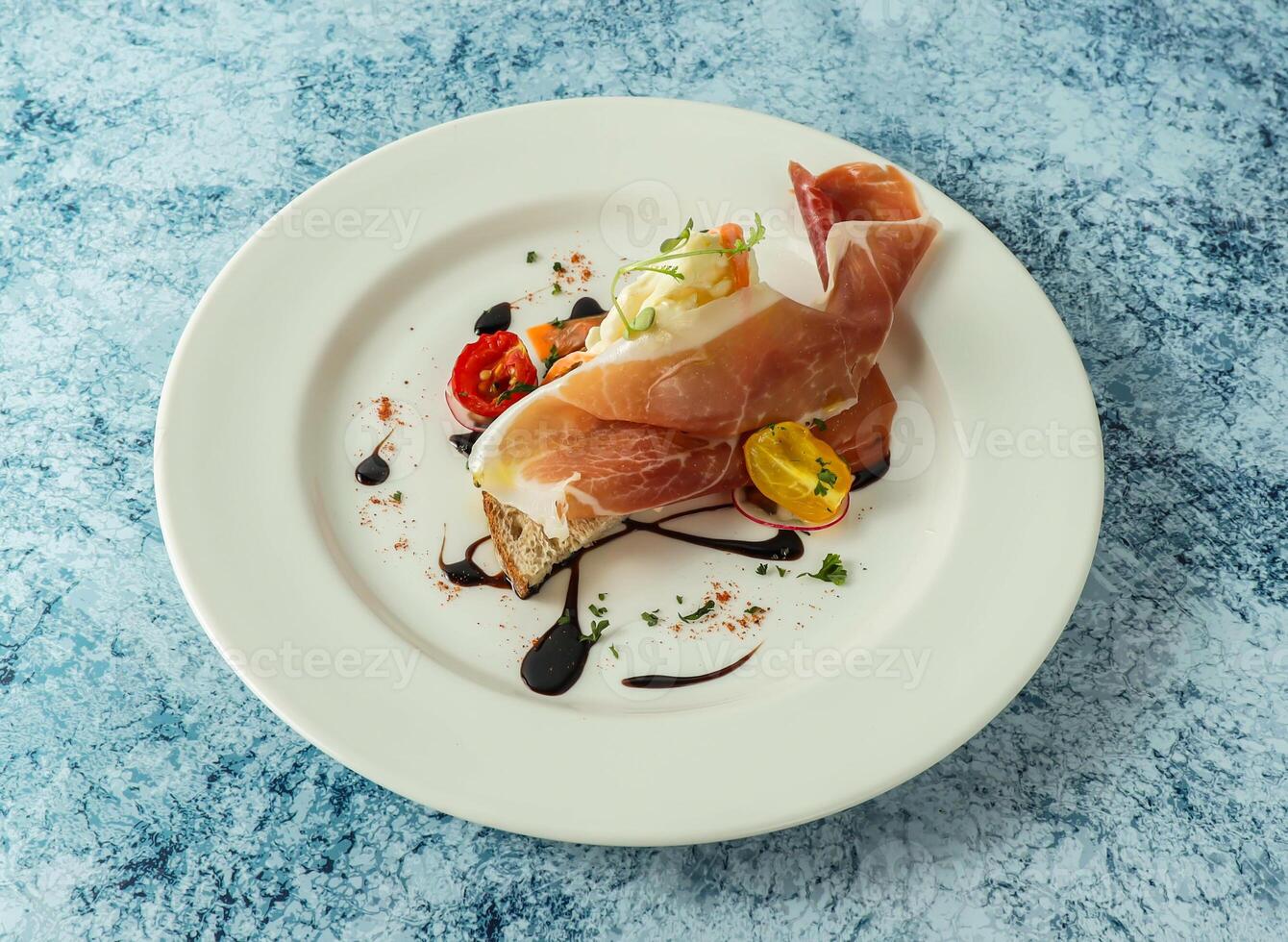 Bruschetta meat sandwich with cheery tomato and lemon served in plate isolated on background top view of italian food photo
