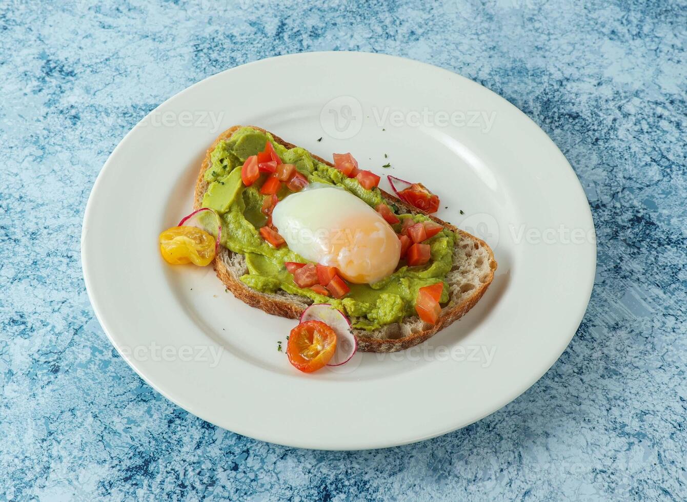 mexican avocado toast with egg and tomato served in plate isolated on background top view of italian food photo