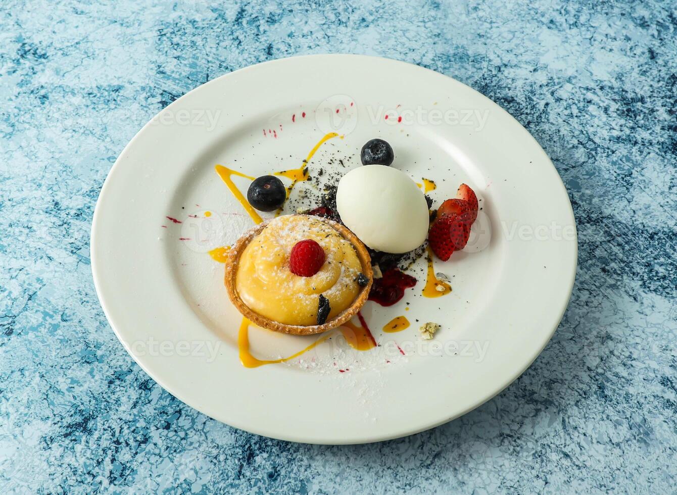 lemon tart with strawberry and blackberry served in plate isolated on background top view of italian food photo