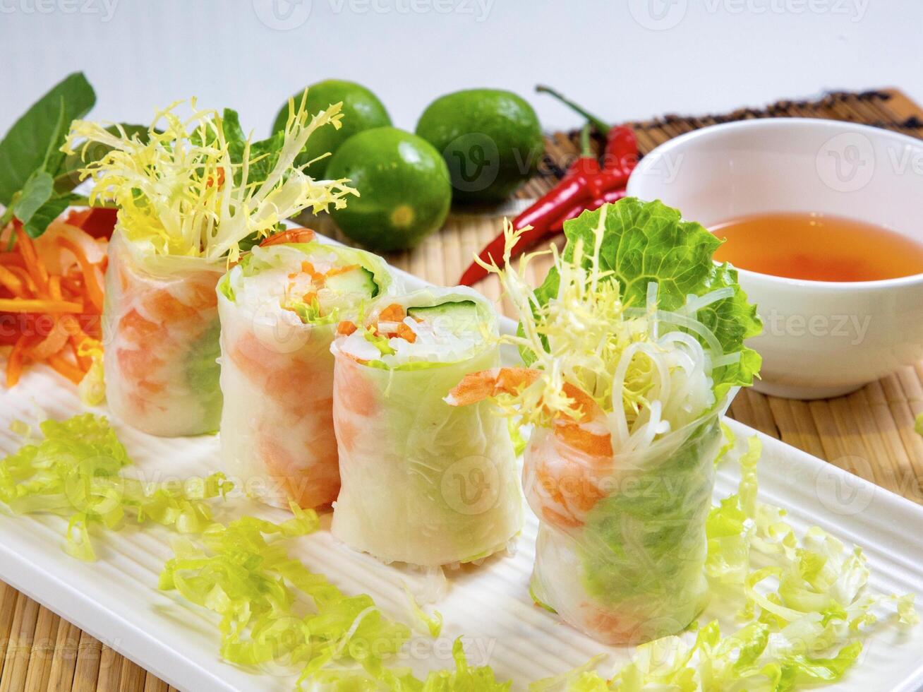 Shrimp Rice Paper Rolls with sauce and lemon served in dish isolated on table top view photo