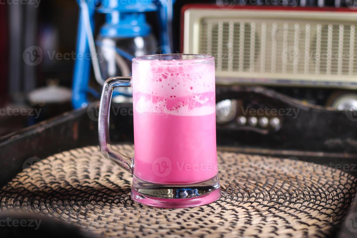Rose milk syrup or gulab shake served in mug isolated on red mat top view on table arabic drink photo