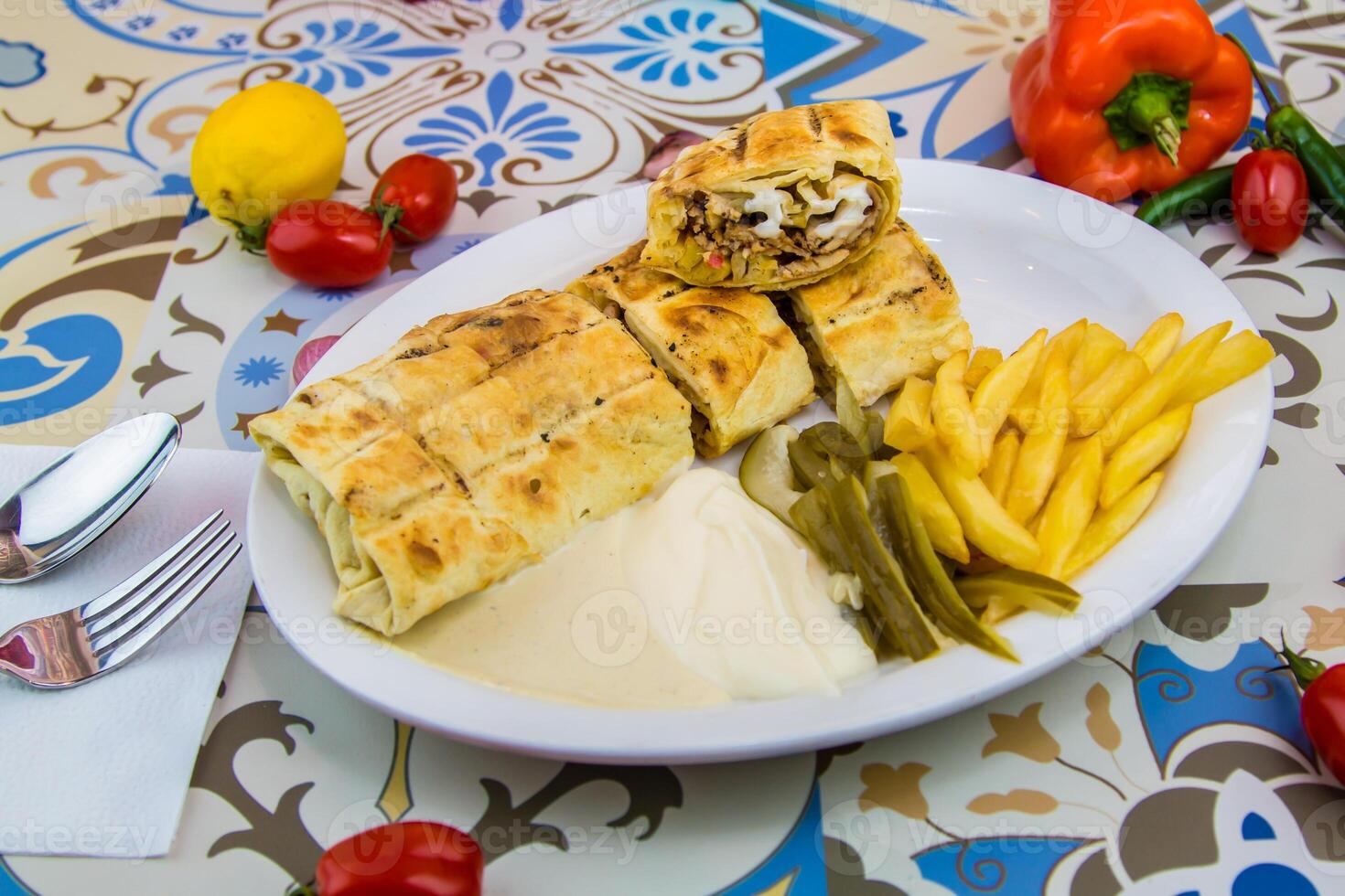 Arabic Shawarma wrap filled with meat and salad served in dish isolated on table top view of arabic food photo