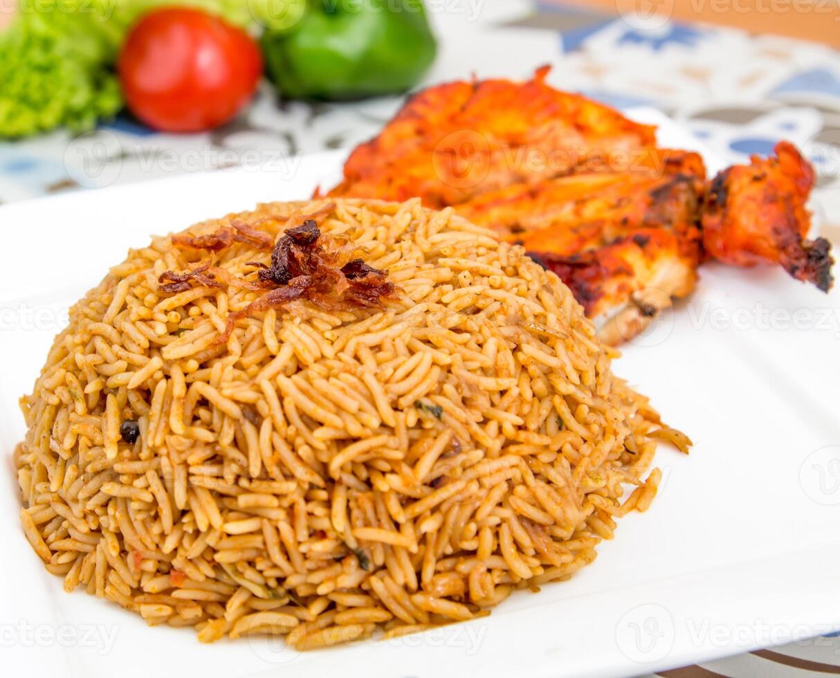 Chicken Bukhari mandi biryani rce pilaf with fried onion served in dish isolated on table top view of arabic food photo