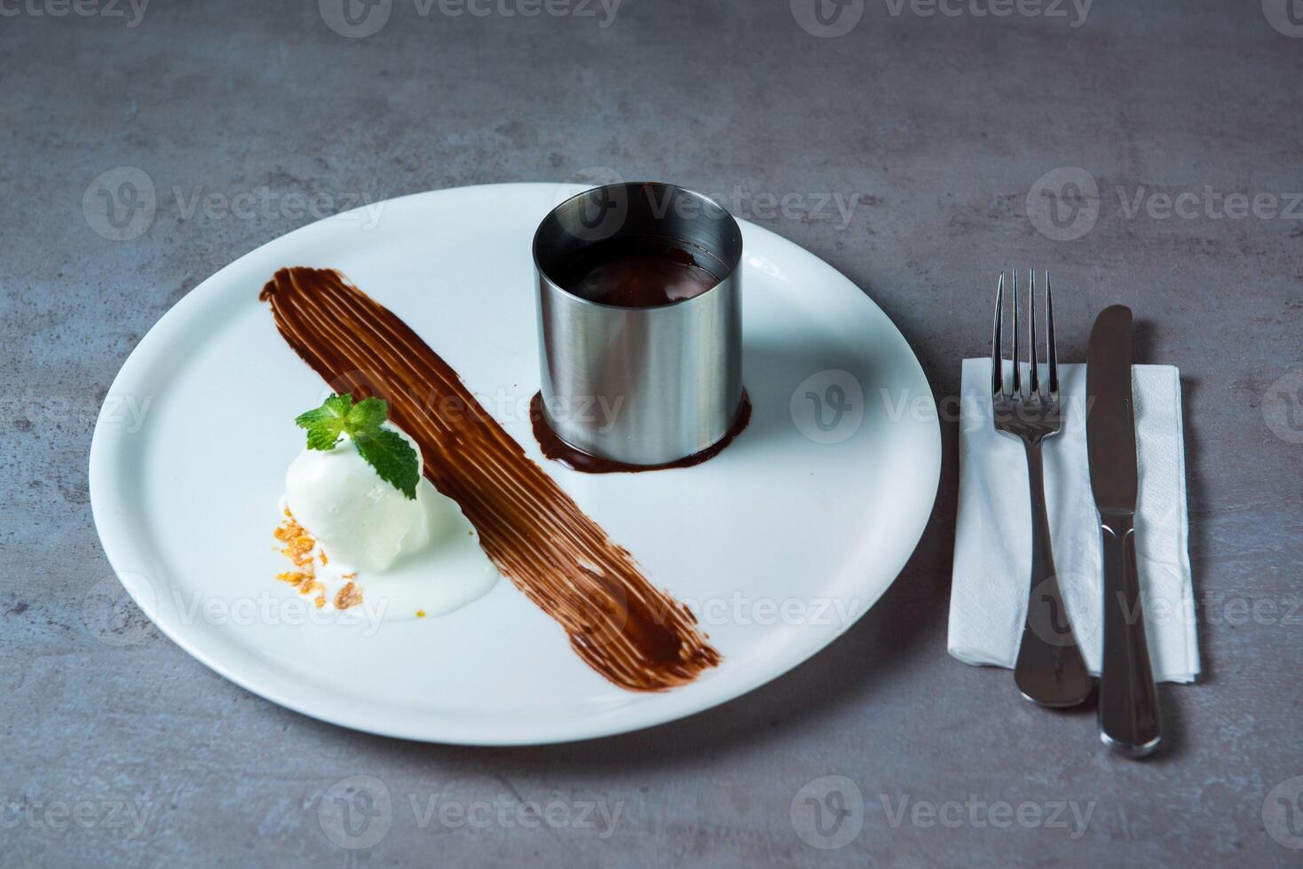 Fondant chocolate with ice ream served in dish isolated on grey background top view of bahrain food photo