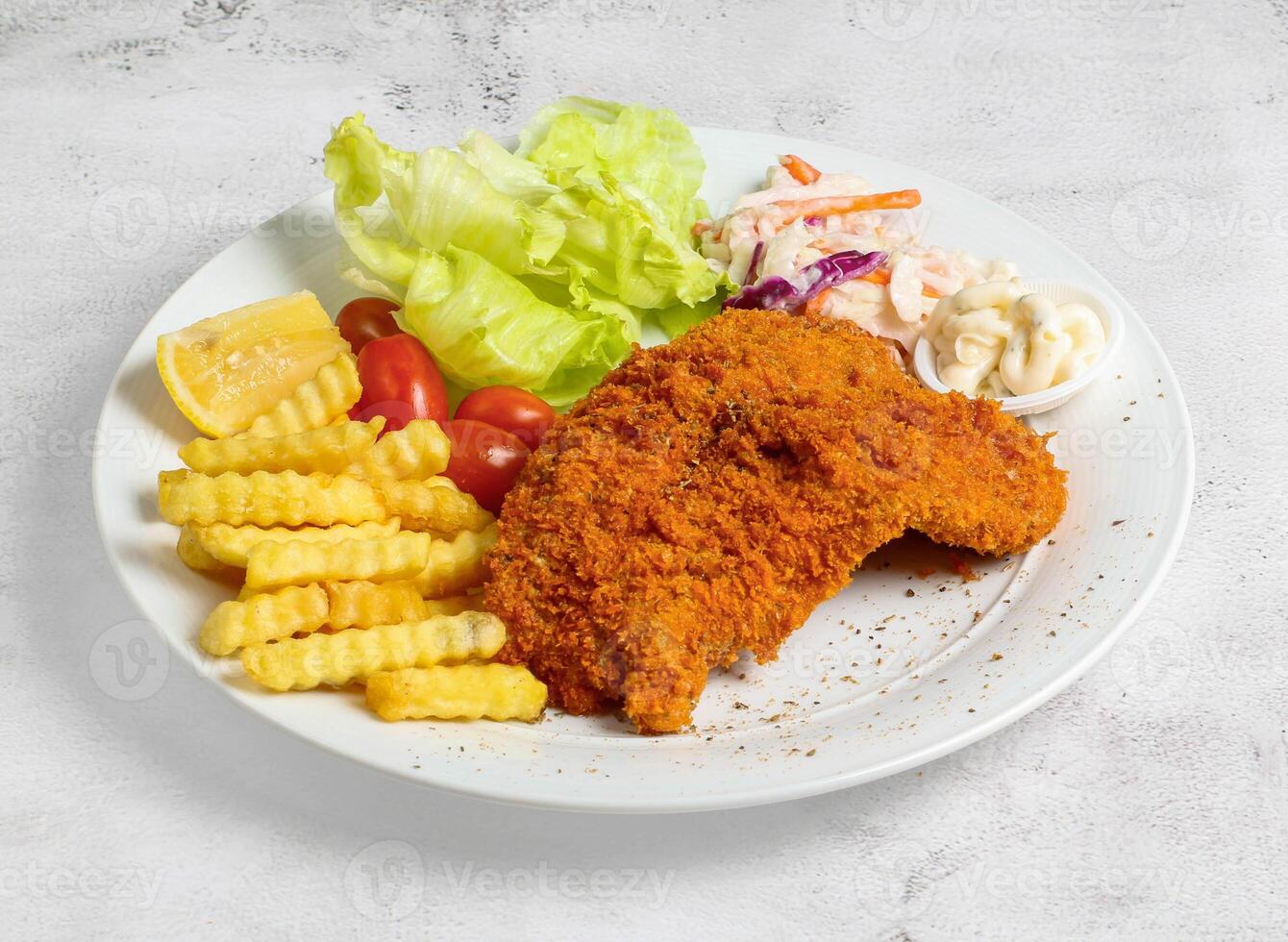 Crispy fish and chips with lime and salad served in dish isolated top view of singapore food photo