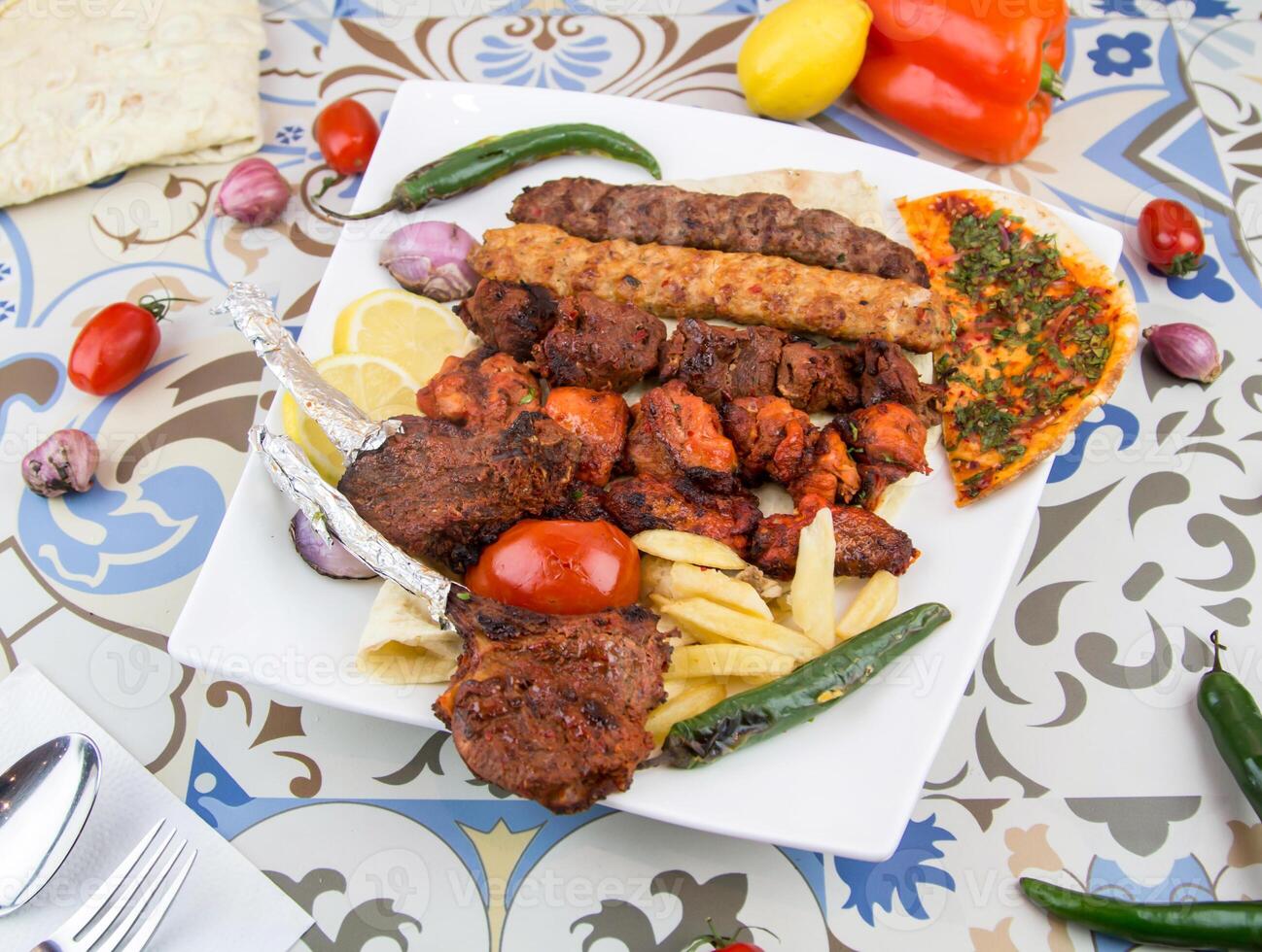 Assorted mix grills with tikka boti seekh kabab of chicken, beef, lamb, mutton bbq platter served in dish isolated on table top view of arabic food photo