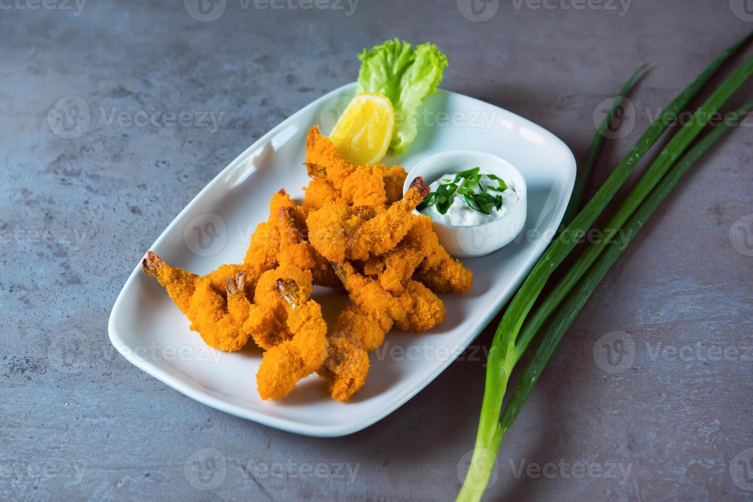 Shrimp fries with mayo dip served in dish isolated on grey background top view of bahrain food photo