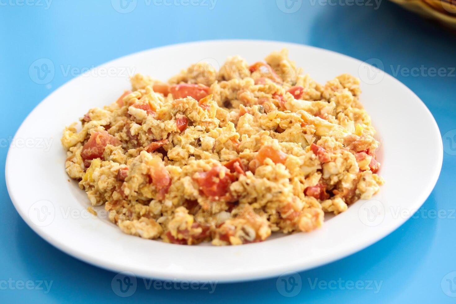 Bahraini Egg And Tomato shaksoka served in dish isolated on wooden table top view middle eastern breakfast food photo