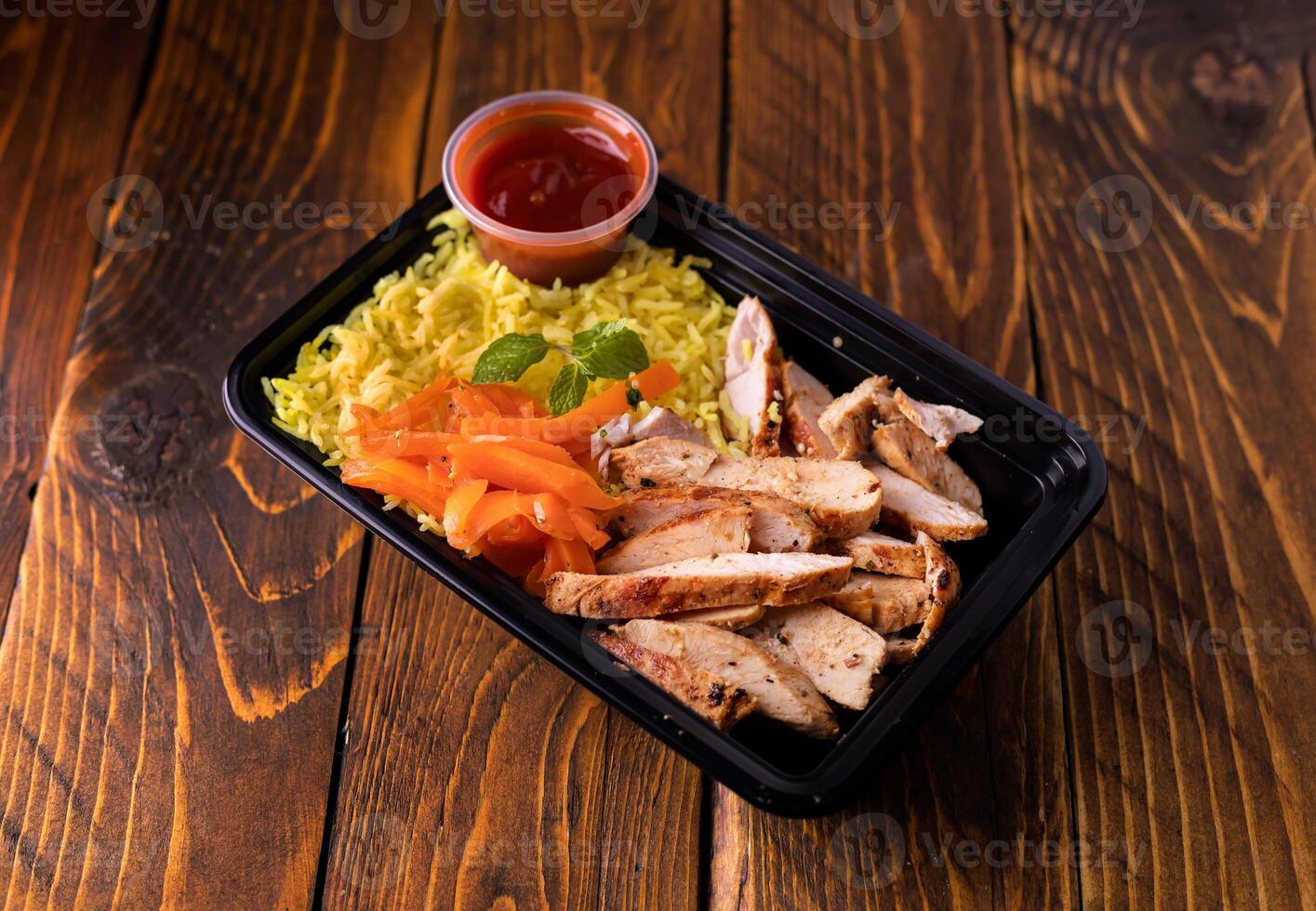 Grill Chicken Slice with Yellow Rice and sauce served in dish isolated on wooden table side view of arabic food photo