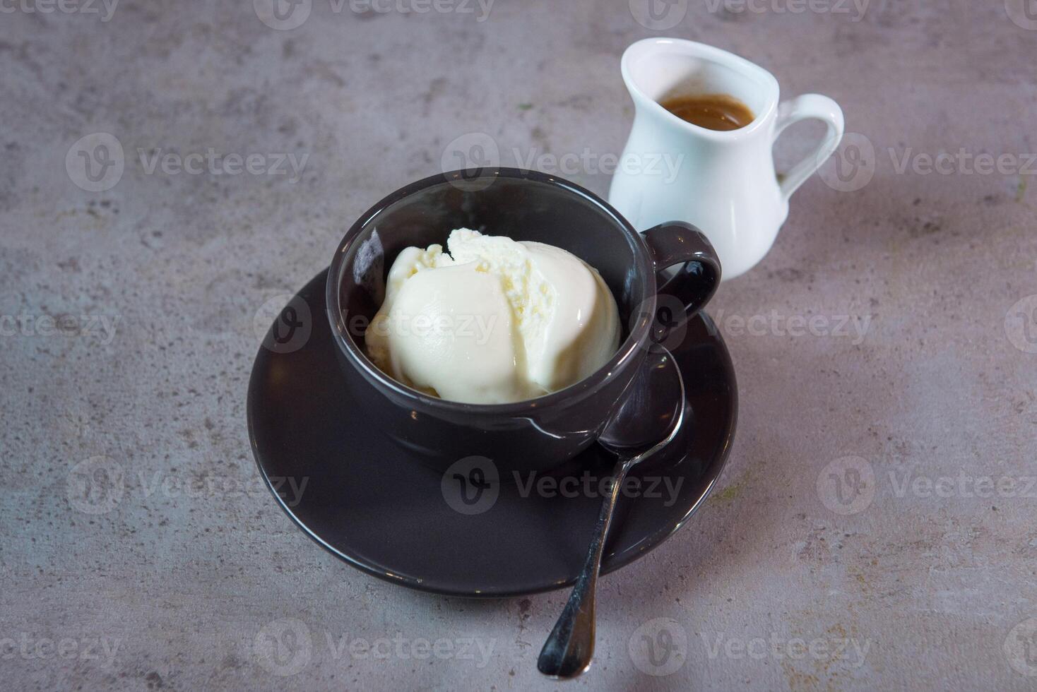 Hot Affogato serving in coffee cup with spoon and beans side view on grey background photo