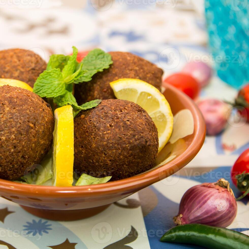 Kibbeh, Kebah, kebbah or kubbah with lime slice served in dish isolated on table top view of arabic food photo