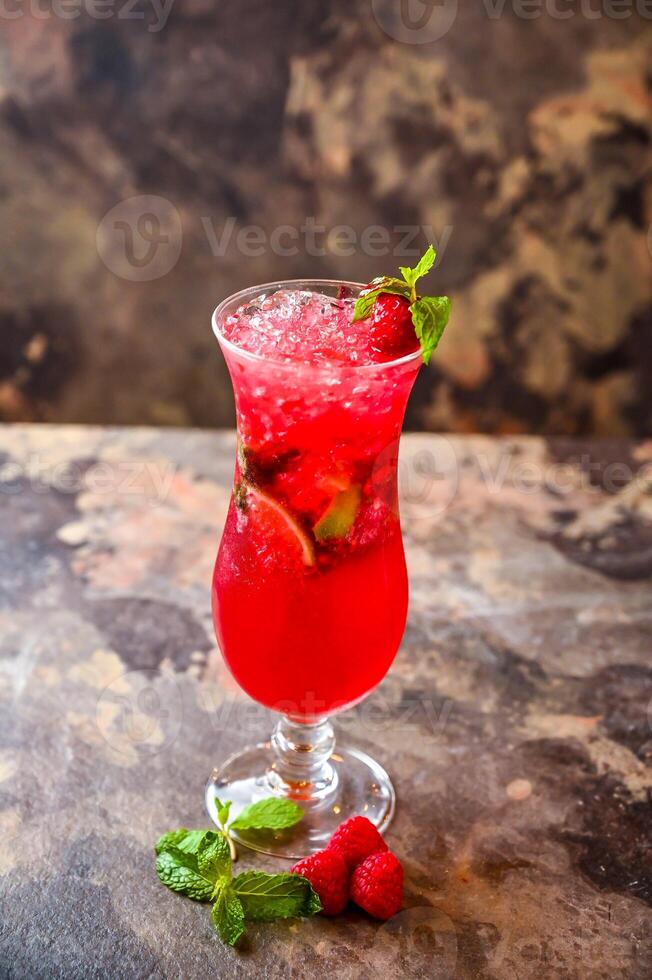 Raspberry and Mint Mojito with lemon slice served in cocktail glass isolated on dark background side view of healthy drink photo