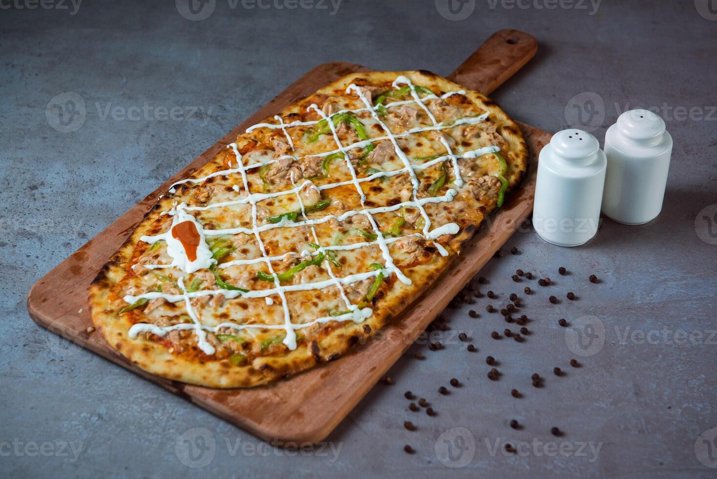 with black pepper Al Tonno Pizza serving on wooden cutting board isolated on grey background top view of fastfood photo