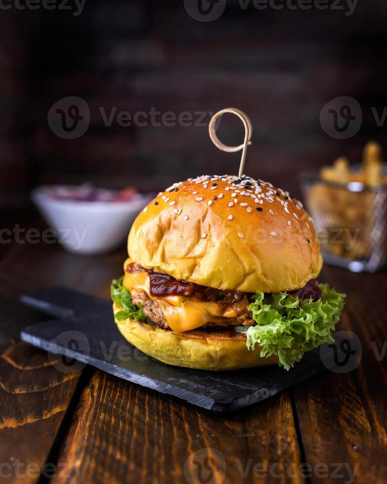 Grill Chicken Burger with melted cheese and lettuce leaves served in dish isolated on wooden table side view of arabic food photo