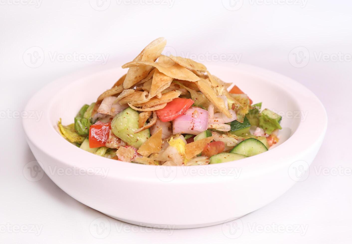 FATTOUSH salad with cucumber, crackers, onion, tomato and lemon served in dish isolated on background side view of arab food photo