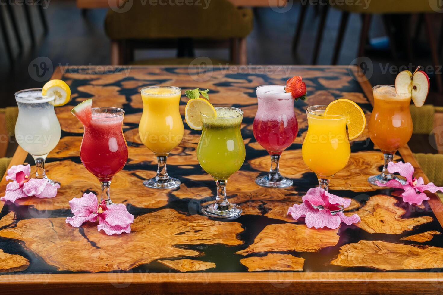 Assorted fruit juice of apple, strawberry, watermelon, passion fruit, mango, orange served in glass isolated on table side view of healthy morning arabic drink photo