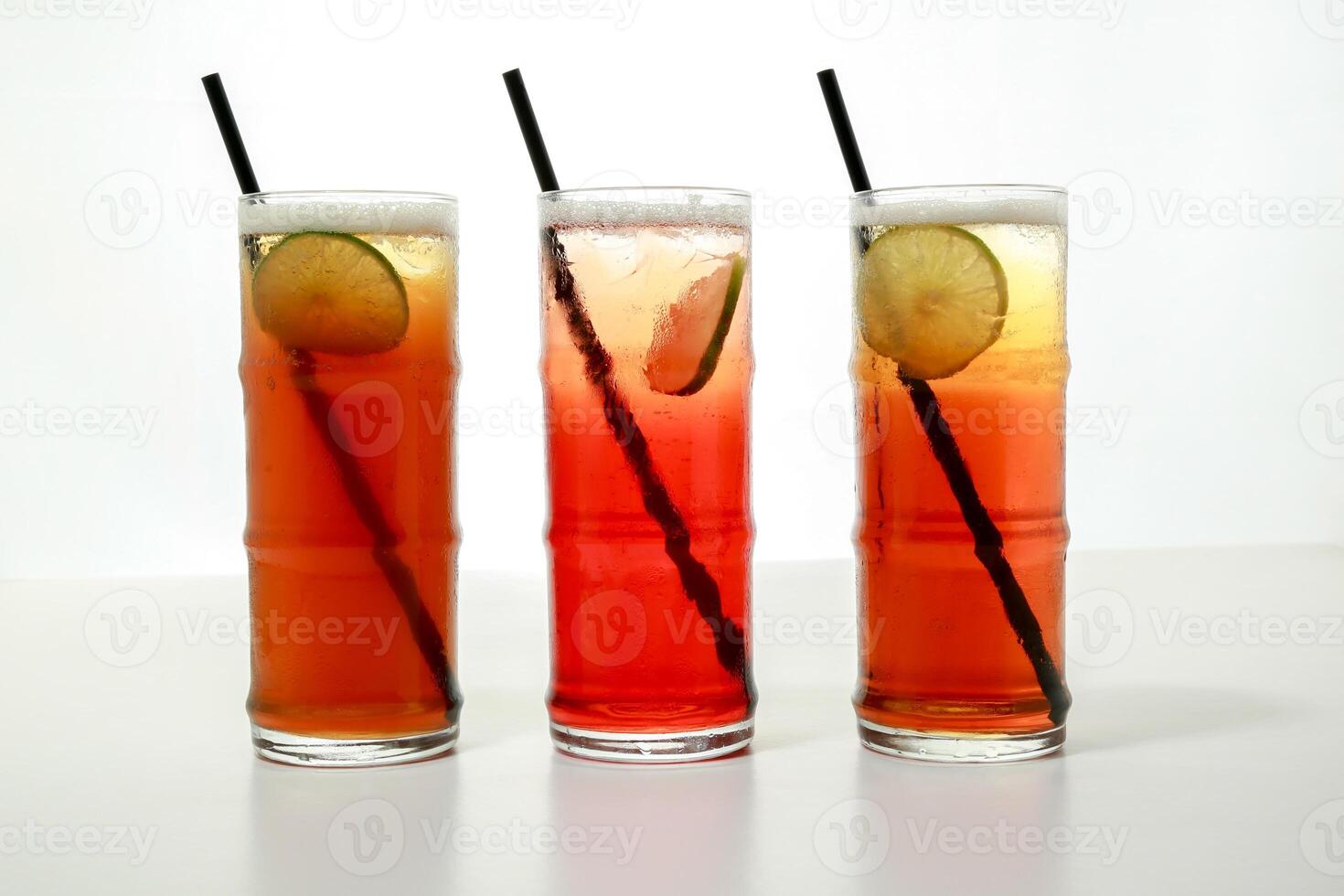 ice tea with lime slice and straw served in glass isolated on grey background side view of healthy morning arabic drink photo