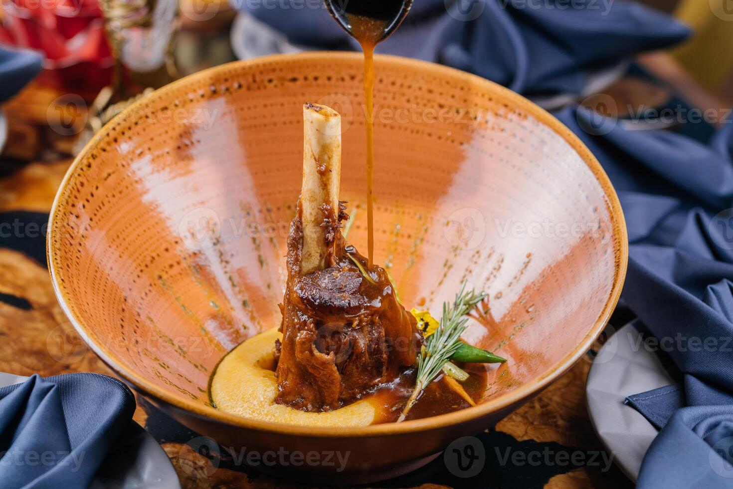 Braised Lamb Shanks or mutton shank served in dish isolated on table top view of meat main course arabic food photo