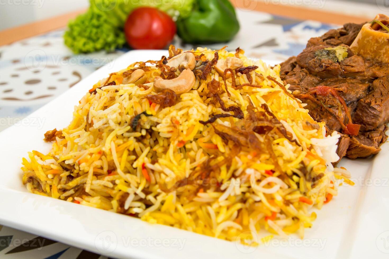 Meat biryani rice with cashew nut served in dish isolated on table top view of arabic food photo