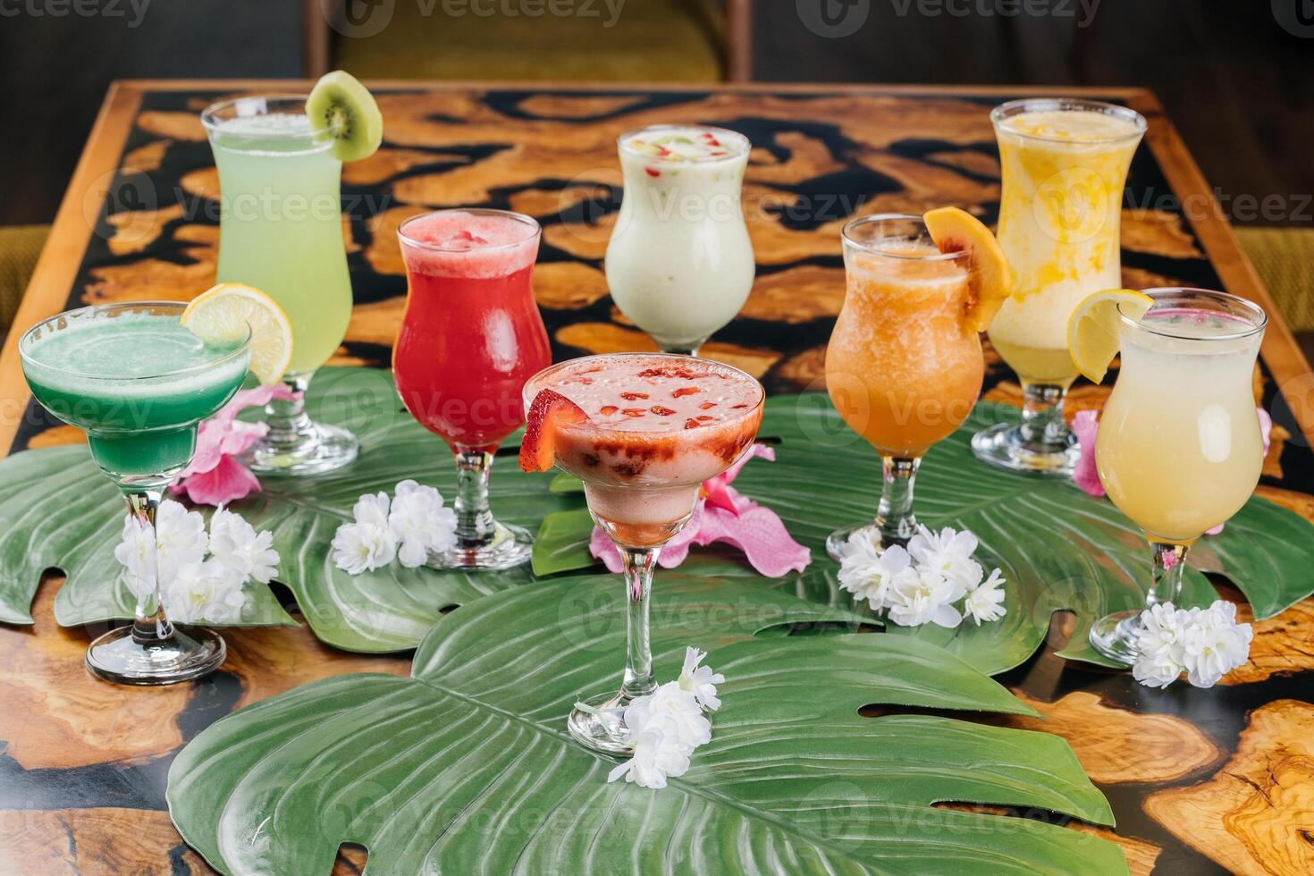 Assorted fruit juice of apple, strawberry, watermelon, passion fruit, mango, orange served in glass isolated on table side view of healthy morning arabic drink photo