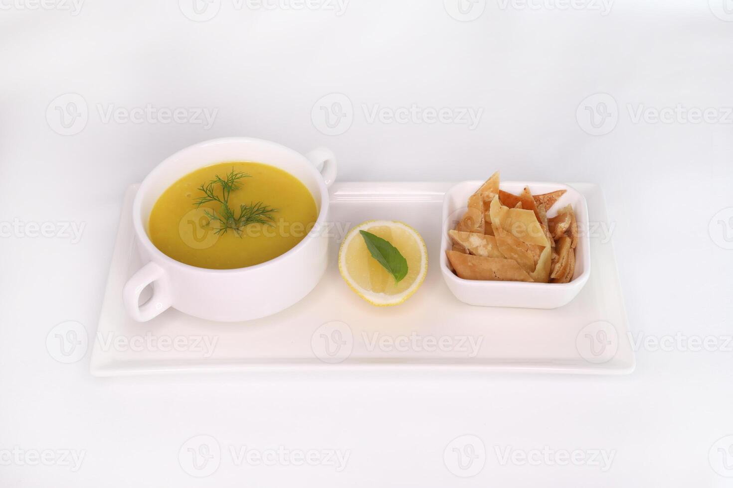 ARABIAN LENTIL SOUP with lemon and crackers served in dish isolated on background side view of arab food photo